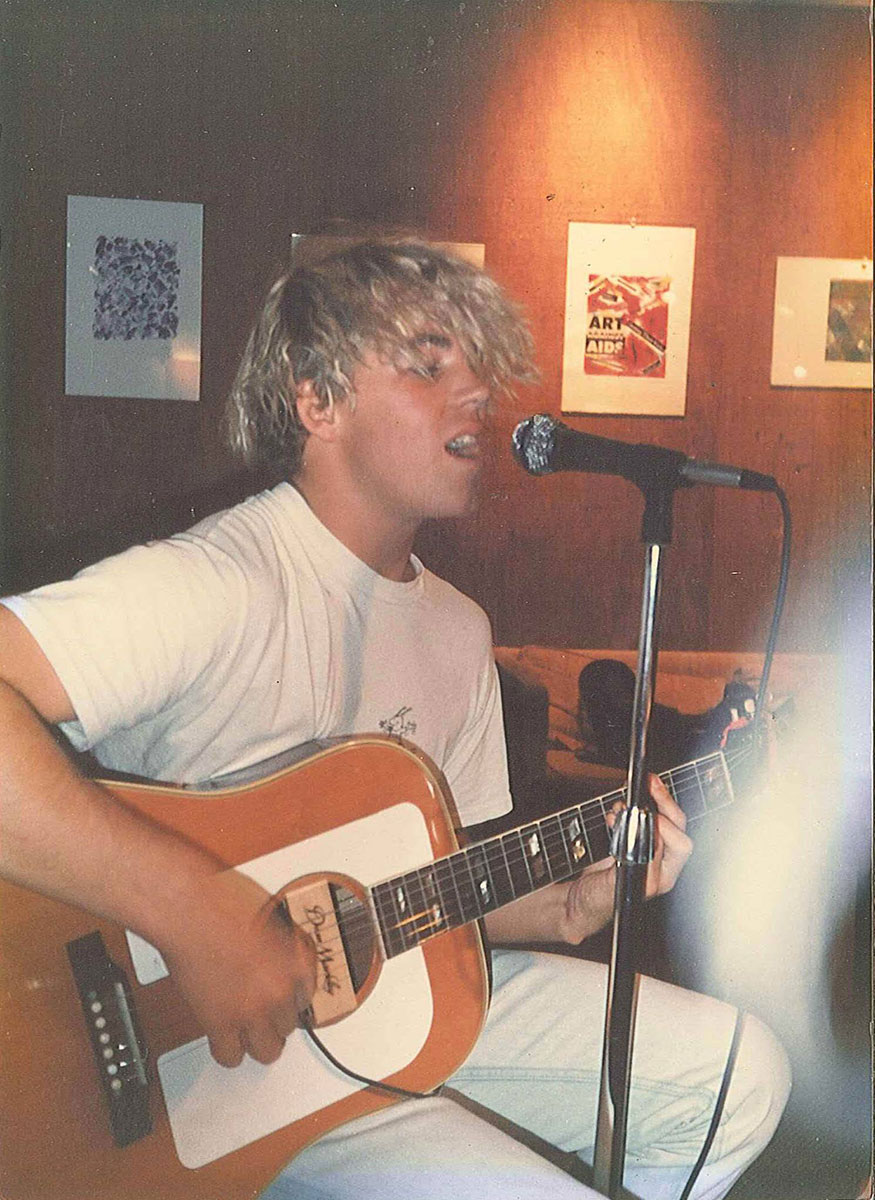 Photo of Bradley Nowell shared by Reid Clow who writes, "One of the main reasons I went to UC Santa Cruz was because Bradley Nowell from Sublime attended the school for his freshman and sophomore years of college. Here is a picture of him strumming what was probably an "X" cover at the Stevenson Café in the 88-90 period."