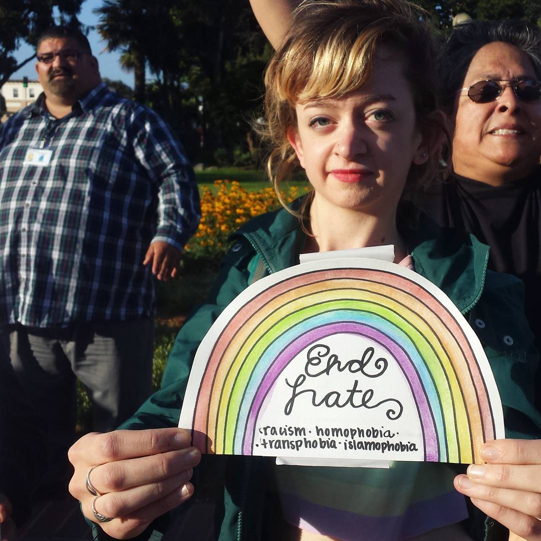 Haley Brown of Santa Cruz holds a sign reading "End Hate: racism, homophobia, transphobia, and islamophobia" at the Watsonville Plaza in solidarity with the people of Orlando and the queer community everywhere. Mayor Felipe Hernandez and SOMOS LGBT President María Luisa Pérez are also pictured.