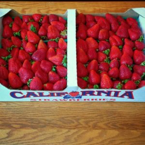 A flat of fresh strawberries, organically grown in the heart of Monterey Bay; Moss Landing, California. These beautiful berries, cultivated with love and sweat, will become Strawberry Jam.