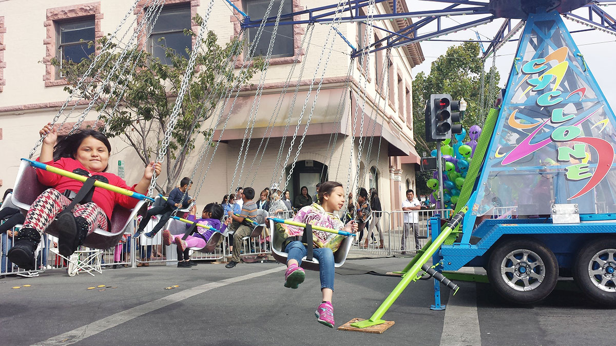Children ride the Cyclone at the Watsonville Strawberry Festival on August 6, 2016.